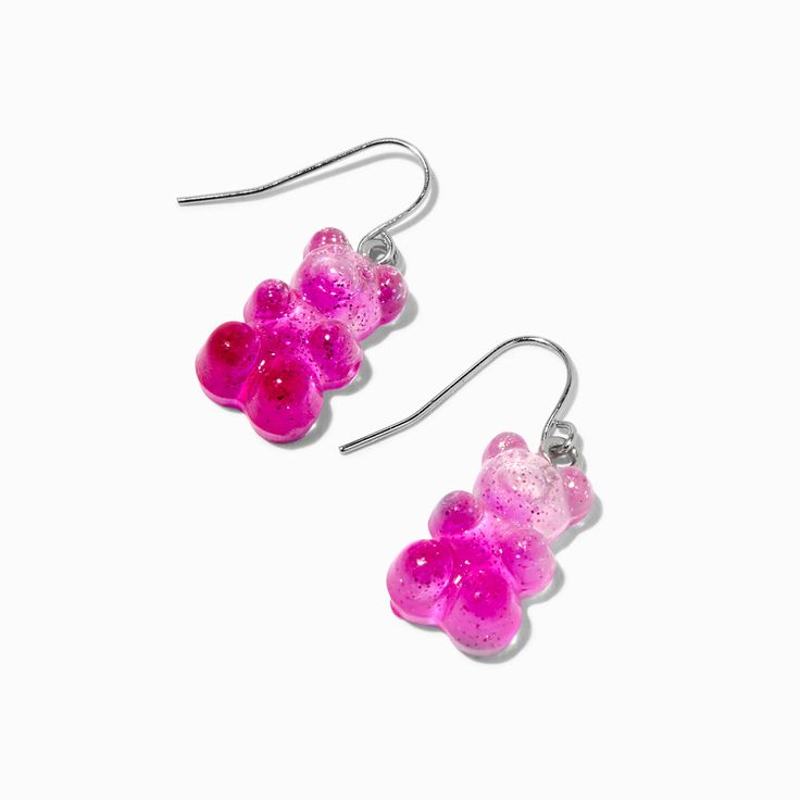 Look as cute and sweet as Gummy Bears® with these earrings! This pair of drop earrings has a pink, glittery Gummy Bears® design hanging from a fish-hook closure. Finish: Silver-tone Drop: 0.5 in. / 1.27 cm. Closure: Fish hook Material: Plastic - Claire's Pink Glitter Gummy Bears® 0.5" Drop Earrings Pink Novelty Dangle Jewelry, Pink Glitter Drop Earrings, Trendy Pink Glitter Earrings, Nickel-free Pink Novelty Earrings, Novelty Pink Nickel-free Earrings, Pink Resin Novelty Earrings, Novelty Pink Hypoallergenic Earrings, Playful Pink Resin Earrings, Novelty Pink Resin Jewelry