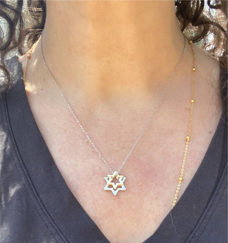 Sterling silver and 14k gold combine in this exquisite, timeless piece.   Discover elegance with our Star of David necklace featuring two delicately crafted pendants. The Star of David pendants shine with the brilliance of sterling silver and 14k gold, symbolizing faith, unity, and heritage. Perfect for everyday wear or as a meaningful gift, this necklace combines traditional craftsmanship with modern style. The adjustable chain (16 inches plus 2 inch extension) ensures a perfect fit, making it a versatile addition to any jewelry collection. Yellow Gold Jewelry With Polished Finish, Star Of David, 14k White Gold Star Of David Necklace, Gold Sterling Silver Star Of David Necklace, Sterling Silver Star Of David Fine Jewelry Necklace, Elegant Star Of David Jewelry With Star Charm, Yellow Gold Star Of David Necklace With Polished Finish, Luxury Silver Star Of David Jewelry, Elegant Yellow Gold Star Of David Necklace, Silver Star Of David Pendant In 14k Gold