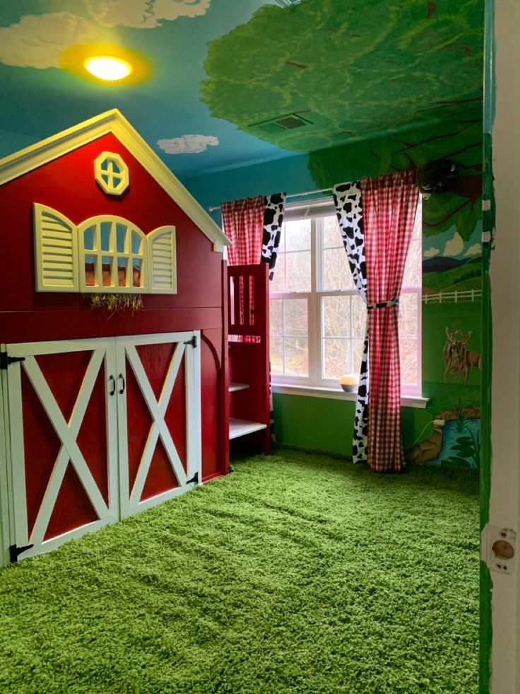 a child's bedroom decorated in red and green with a horse themed mural on the ceiling