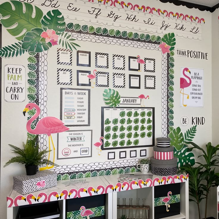 a room decorated in pink, green and white with flamingos on the wall next to it