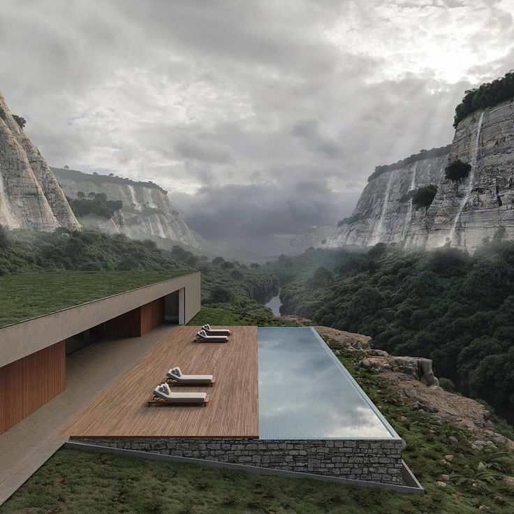 an outdoor swimming pool with chaise lounges overlooking the mountains