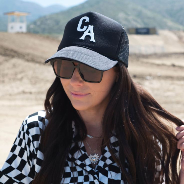 Our trucker style hat is the perfect accessory for errands, a playdate, the big soccer game or basically any occasion at all. *ALL HATS ARE FINAL SALE* 100% POLYESTER - One size fits most - Foam front, mesh back and terry sweatband - Black Otto 39-165 hat - Custom white puff lettering "CA" - Adjustable snap back Care Instructions: Spot clean only. Can be gently steamed if bent or creased. Black Retro Trucker Hat For Summer, Retro Black Trucker Hat For Streetwear, Retro Black Trucker Hat For Sports, Trendy Snapback Hat For Baseball Season, Casual Trucker Hat For Sports Events In Spring, Mesh Hats For Sports Events In Summer, Summer Mesh Hat For Sports Events, Retro Black Trucker Hat With Curved Brim, Sporty Trucker Hat With Visor For Spring