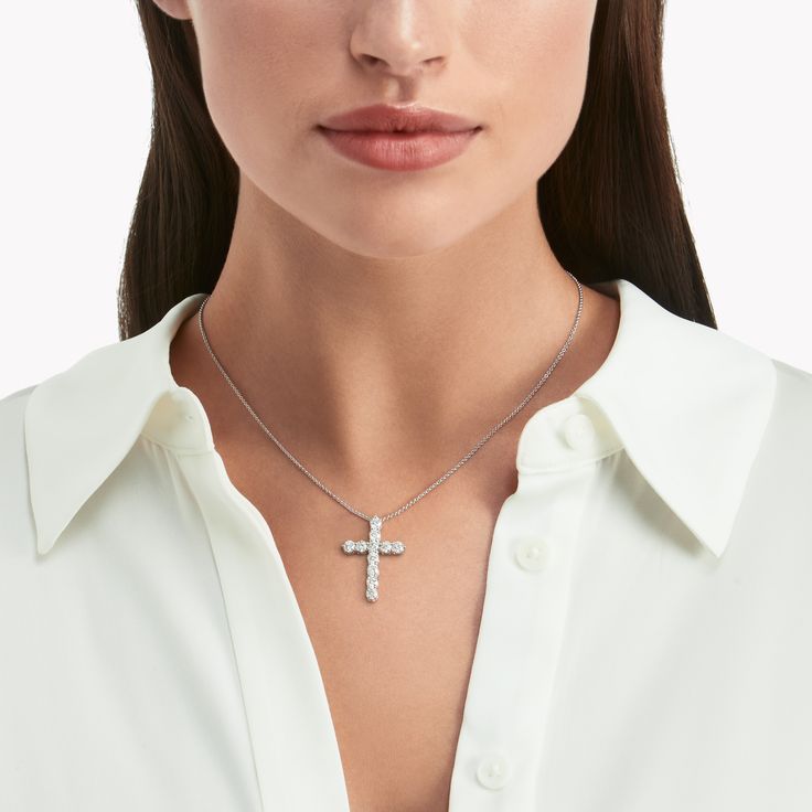 A precious interpretation of a classic motif, our medium cross pendant in white gold is available in a variety of different carat weights, seen here with 0.15 carat diamonds. Deftly suspended from a white gold chain, each diamond is embraced by a minimal metal setting, optimising their brilliance and presence. The Classic Graff collection celebrates the purity and fire of the finest Graff diamonds showcased in truly timeless jewels and eternally elegant silhouettes. A precious interpretation of Luxury White Gold Cross Necklace With Diamond Accents, Elegant Silver Cross Diamond Necklace, Elegant Silver Cross Necklace, Elegant White Cross Necklace Pendant, Elegant White Cross Pendant Necklace, Elegant White Pendant Cross Necklace, Elegant Diamond White Cross Necklace With Diamond Accents, Elegant Diamond Cut Cross Necklace In Diamond White, Elegant Brilliant Cut Cross Pendant Necklace