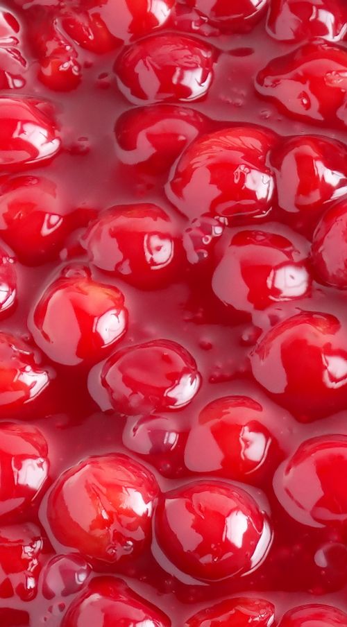 red jelly is being poured on top of it's surface with water droplets in the middle