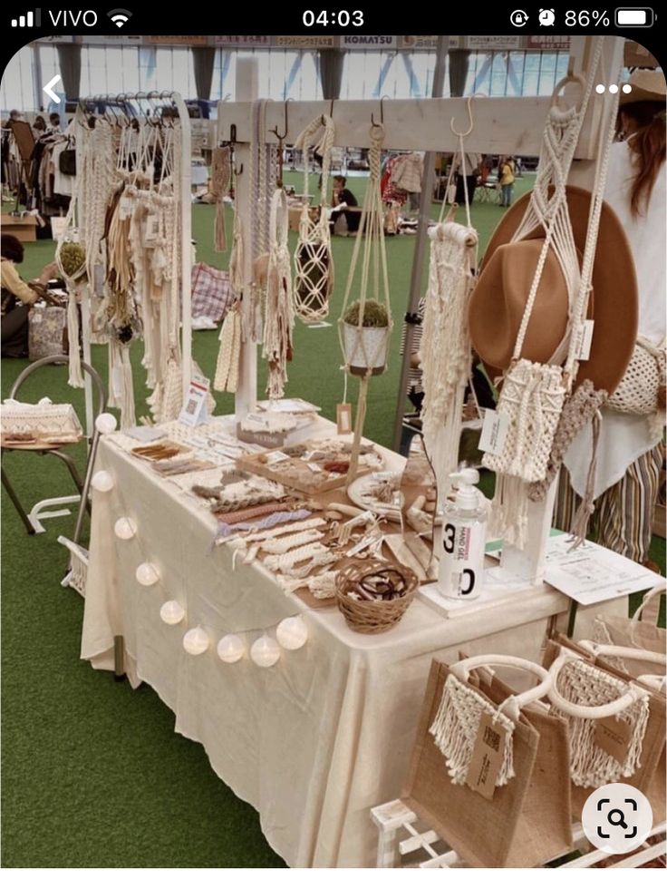 an outdoor market with many items for sale on the table, including hats and other things