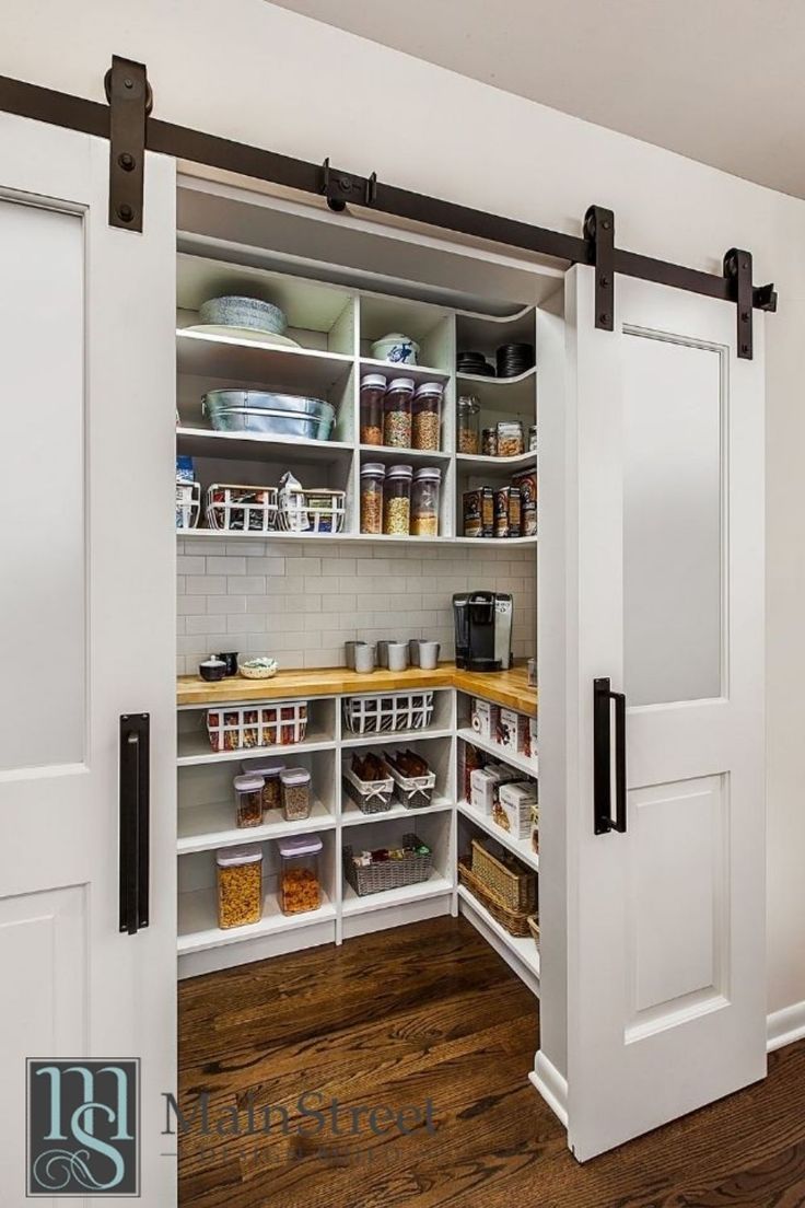 an open pantry with sliding doors and shelves