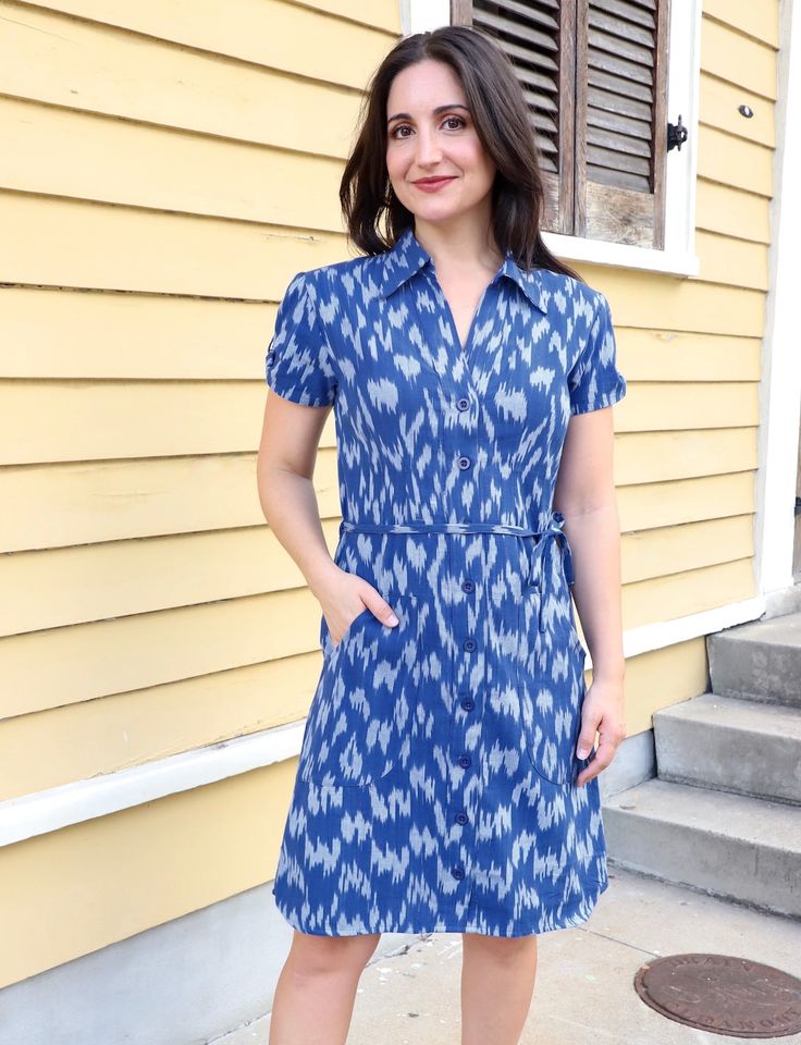 You'll feel regal in our Majestic Cotton Button Dress. Designed in royal blue ikat fabric, this dress boasts a refined collar, a flattering tie waist, and charming gathering at the sleeves. The front buttons add a classic touch, making it the perfect choice for a sophisticated and timeless look that stands out in any setting. Easy-to-open cotton button dress that is great for nursing or pumping mothers. FIT Model is 5'3" and wears S True to size. If in between sizes, size up This fabric does not Fitted Cotton Shirt Dress With Tie Waist, Elegant Spring Dress With Ikat Print, Fitted Collared Shirt Dress With Tie Waist, Fitted Cotton Dress With Collared Neckline, Blue Belted Button-up Dress, Blue Collared Dress With Tie Waist, Blue Cotton Belted Shirt Dress, Fitted Ikat Print Dress, Classic Collared Dresses With Tie Waist