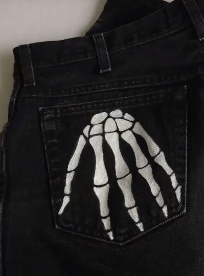 Customised Jeans Paint, Bleached Black Jeans Design, Black Painted Pants, Jean Pants Painting Ideas, Paint On Black Jeans, Painting On White Jeans, Black Jeans Embroidery Ideas, Bleach Black Jeans Diy Ideas, Halloween Jeans