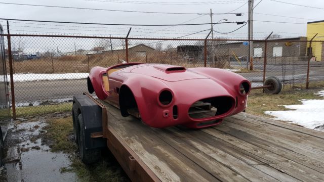 a red sports car sitting on top of a wooden ramp