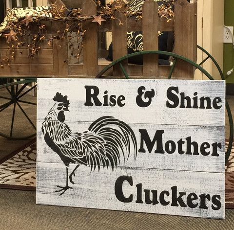 a wooden sign that says rise and shine mother cluckers with a rooster on it