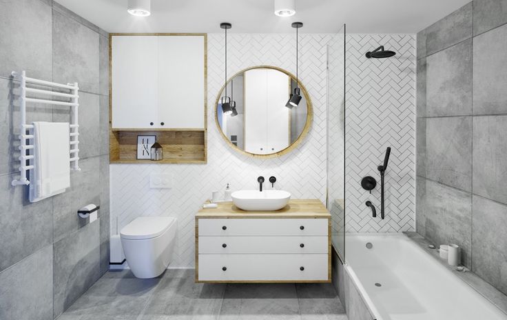 a bathroom with a sink, toilet and bathtub next to a shower head mounted on the wall