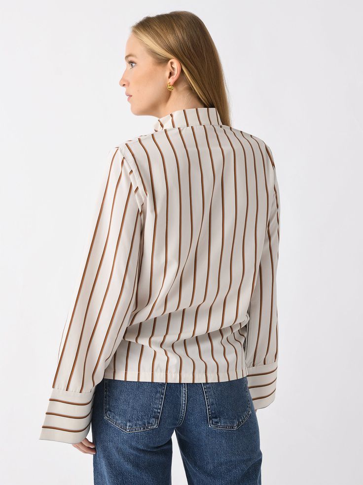 DESCRIPTION:An oversized striped shirt featuring a high band collar, split neckline, and long wide sleeves.FEATURES:Band CollarSplit NecklineWide SleevesAll-Over Stripe Print88% Viscose, 12% PolyamideRelaxed FitModel is wearing size Small shirt.Model's Measurements: Height: 5'9.5" | Bust: 32C | Waist: 26.5" | Hips: 37" | Dress Size: 2-4 (US) Daywear Blouse With Striped Collar And Button-up Shape, Classic Button-up Tops With Contrast Stripes, Oversized Striped Shirt, Cotton Button-up Tops With Horizontal Stripes, Cotton Button-up Top With Contrast Stripes, Long Sleeve Cotton T-shirt With Horizontal Stripes, Denim Sweater, Band Collar, Dress Pant