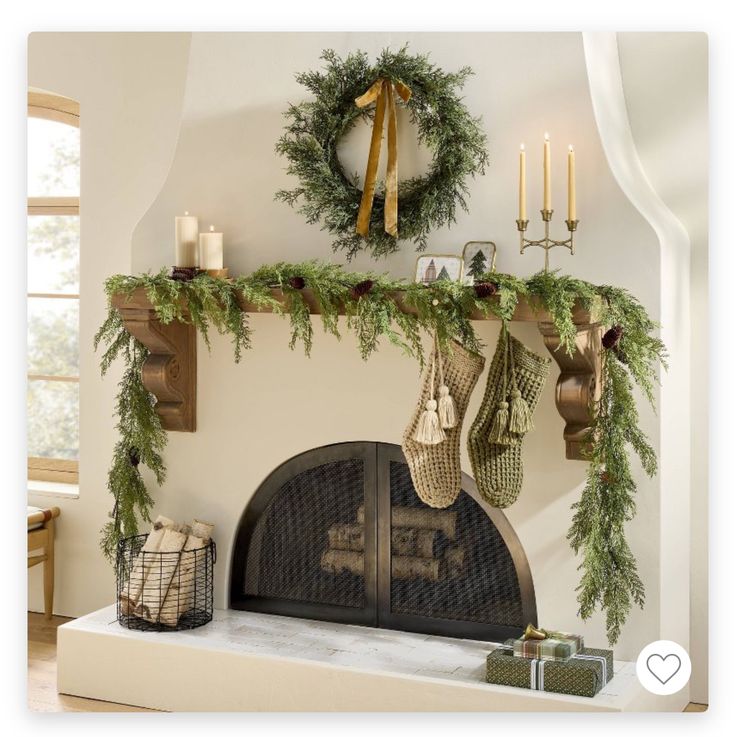 a fireplace decorated for christmas with wreaths and stockings