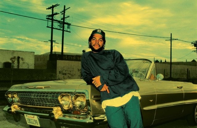 a man leaning on the hood of a car