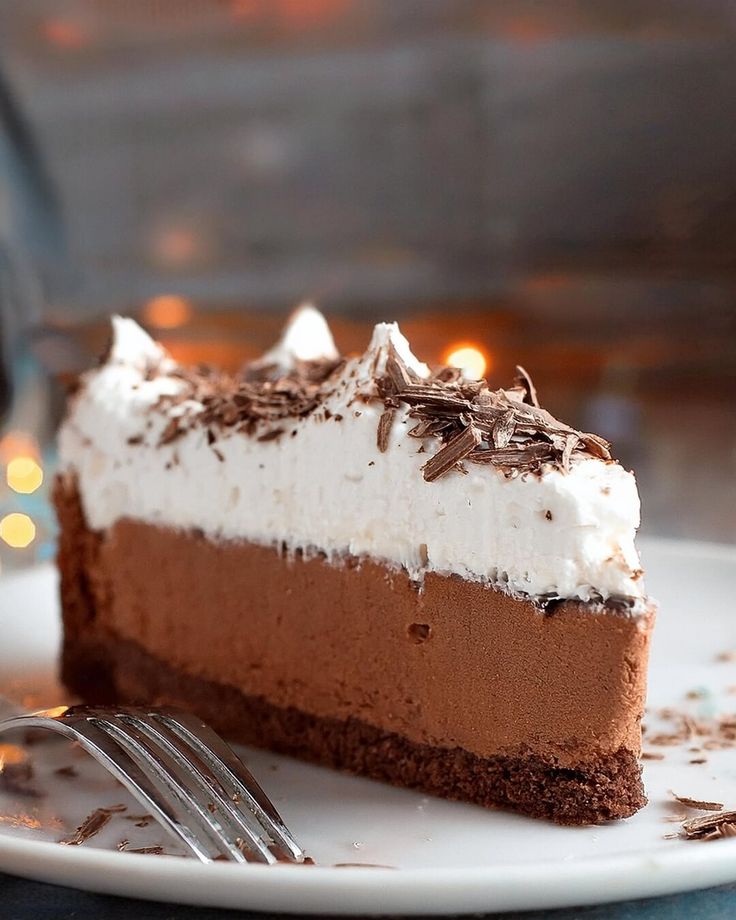 a piece of chocolate pie on a plate with a fork