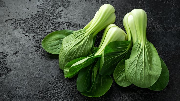 some green leafy vegetables on a black surface