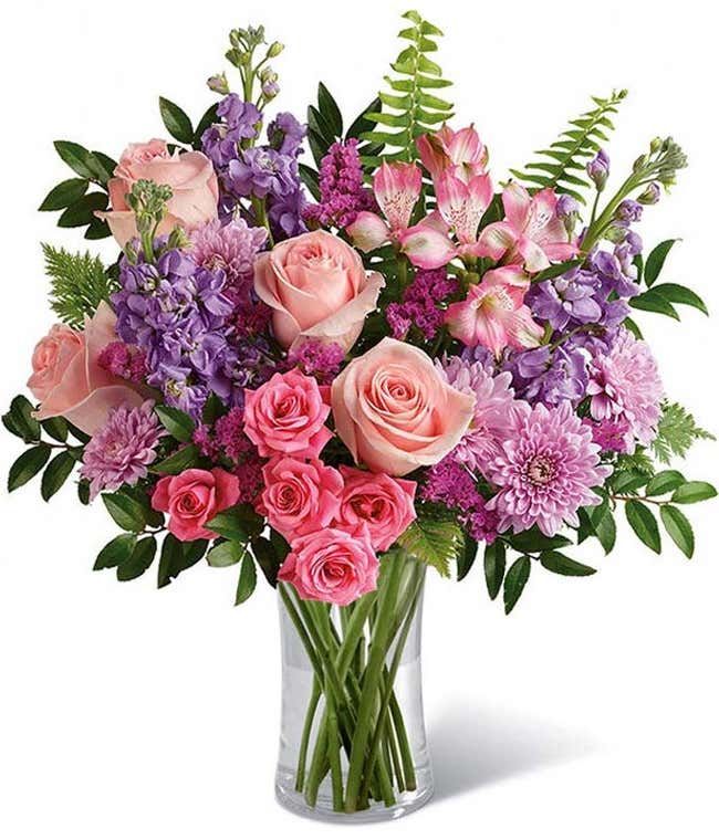 a vase filled with pink and purple flowers