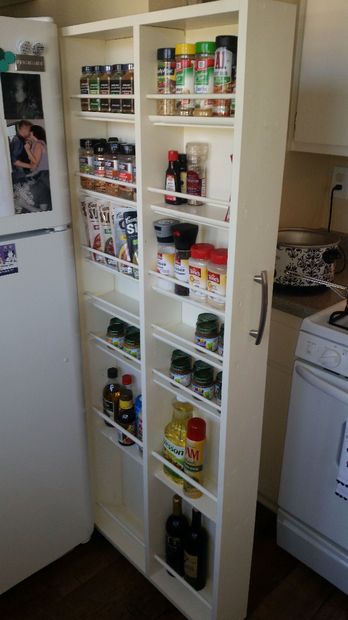 a refrigerator and pantry in a small kitchen