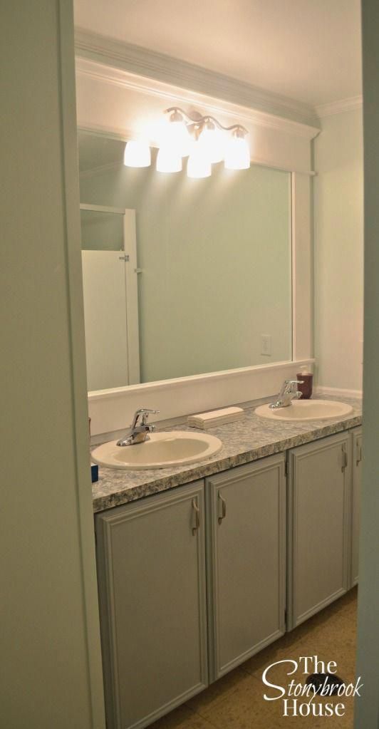 a bathroom with two sinks and a large mirror