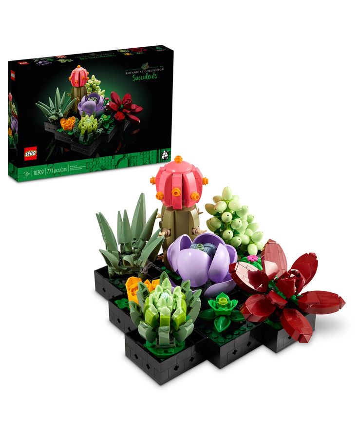 a lego planter with flowers and plants in it next to a box that has the same design on it