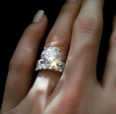 a woman's hand with a diamond ring on it