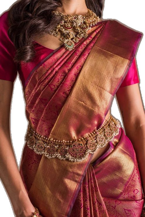 a woman in a pink and gold sari