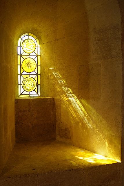 a light shines through a stained glass window