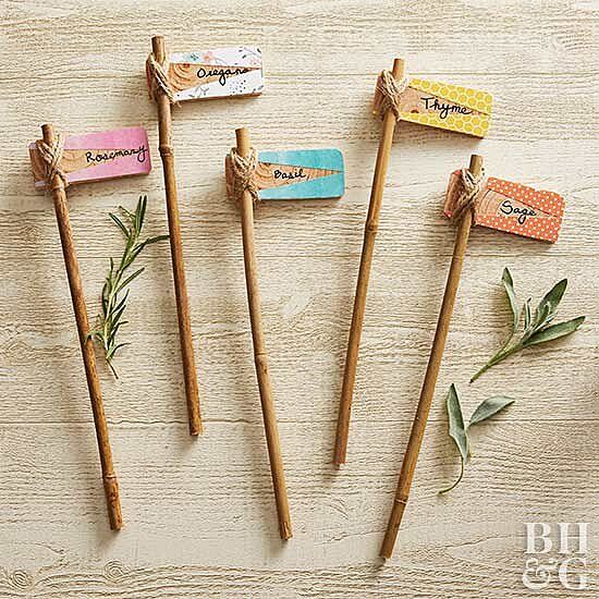 four toothpicks are arranged on top of each other, with herbs and tags attached to them