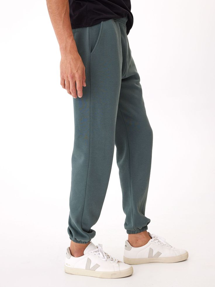 Our classic jogger made with our Invincible fabric. Odor and liquid resistant, quick-drying and nano free technology make this fleece jogger truly revolutionary. A buttery soft blend of organic cotton and recycled polyester, bluesign certified and designed with side pockets, a back patch pocket and a mid rise elastic waist band. Throw them in the washer and dryer without fear of losing it's super powers. There simply isn't a better jogger out there. Everyday Activewear In Recycled Polyester, Everyday Solid Activewear In Recycled Polyester, Cotton Sweatpants For Sports With Straight Hem, Cotton Sweatpants With Straight Hem For Sports, Comfortable Fleece Joggers With Elastic Waistband, Green Relaxed Fit Tapered Leg Joggers, Sporty Sweats With Elastic Waistband And Straight Hem, Casual Fleece Joggers With Comfort Waistband, Cotton Sweats With Elastic Waistband For Jogging