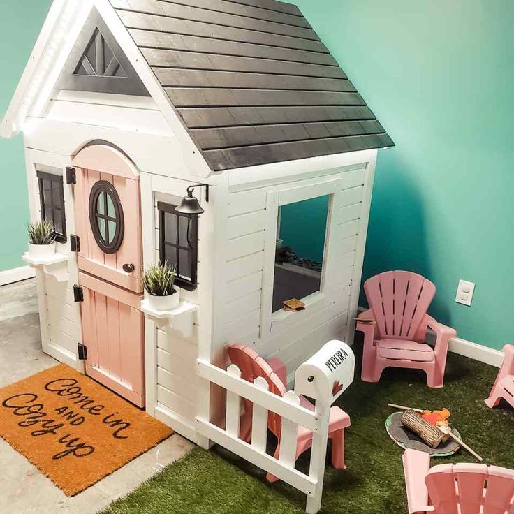 a kid's play house made out of plastic chairs and a door with windows