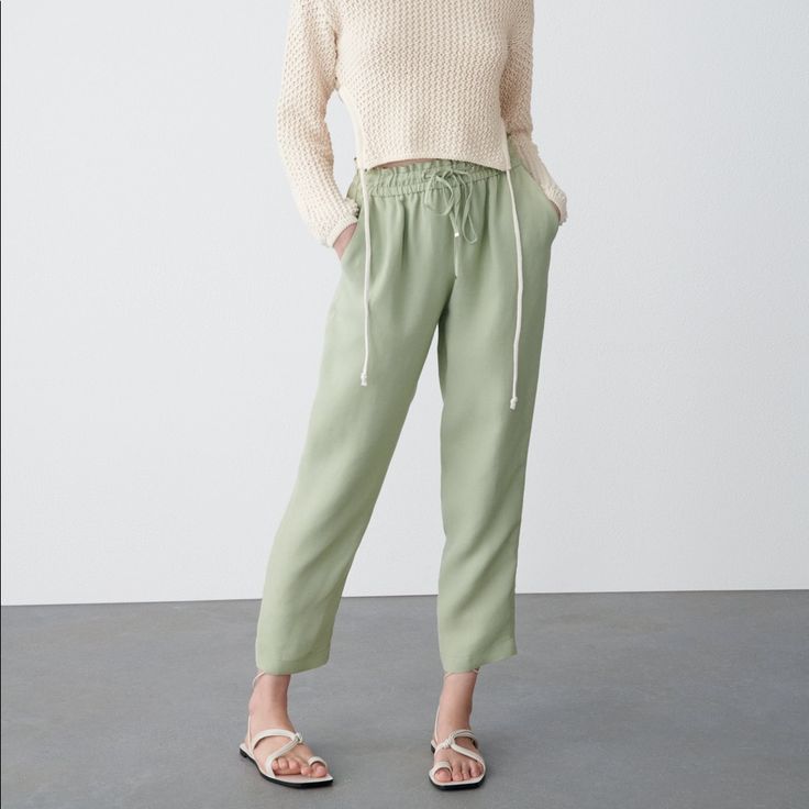 High-Waist Trousers With An Elastic Waistband And An Adjustable Drawstring. Front Pockets, Decorative Welt Pocket At The Back. Light Khaki . Full Waist 26” And Beyond.Length 38” Inseam 27” Rise 11” Zara Casual Bottoms With Elastic Waistband, Green Tapered Leg Pants With Pull-on Style, Zara Casual Sweatpants With Elastic Waistband, Versatile Ankle-length Pants For Spring, Chic Relaxed Fit Pants With Drawstring, Casual Pants With Elastic Waistband For Daywear, Trendy Tapered Leg Bottoms With Elastic Waistband, Relaxed Fit High-waisted Sweatpants For Spring, High-waisted Relaxed Fit Sweatpants For Spring