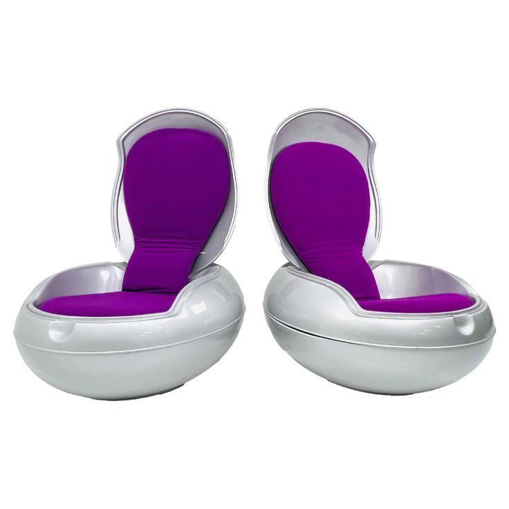 two white and purple chairs sitting next to each other on top of a white floor