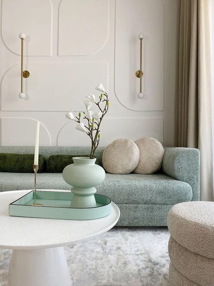 a living room filled with furniture and a white coffee table in front of a couch