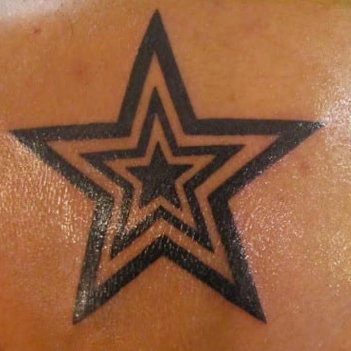 a star tattoo on the back of a woman's upper arm and shoulder area