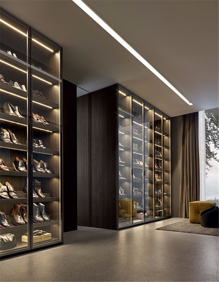 a walk in closet filled with lots of shoes