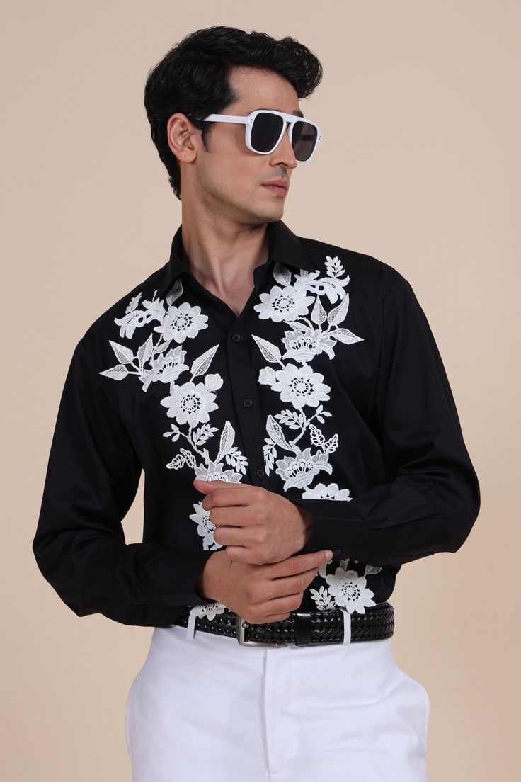 Black shirt with floral applique embroidery and cuff sleeves.
Component: 1
Pattern: Embroidered
Type Of Work: Applique
Neckline: Shirt Collar
Sleeve Type: Cuff Sleeves
Fabric: Cotton
Color: Black
Other Details: 
Note: Pant and belt worn by the model is not for sale
Occasion: Party - Aza Fashions Raghavendra Rathore, Applique Shirts, Applique Embroidery, Embroidered Applique, Floral Applique, Floral Shirt, Shirt Collar, Cuff Sleeves, Aza Fashion