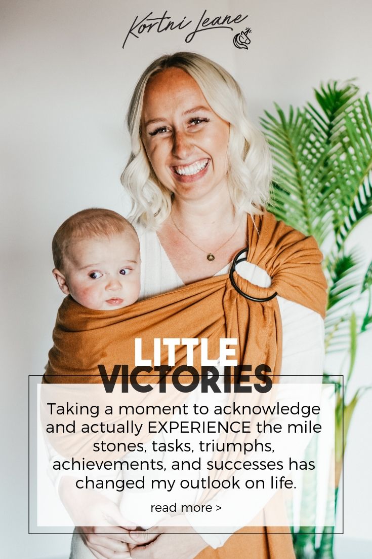 a woman holding a baby in her arms with the words little victorias on it