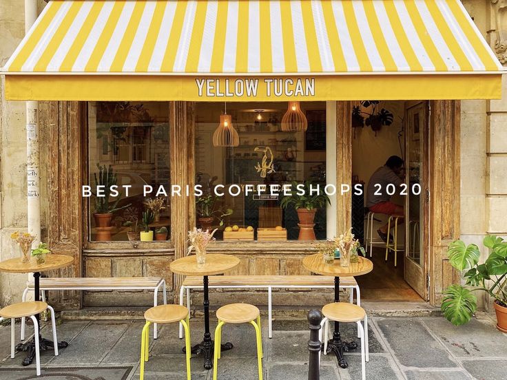 the yellow tucan storefront has two tables and chairs outside