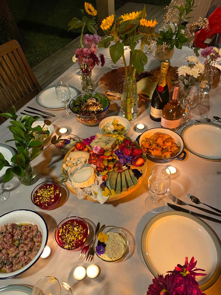 the table is set with many plates and bowls