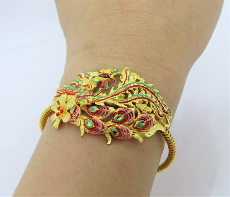 Vintage 24K 980 Pure Gold Enamel Peacock, Phoenix Bracelet ....Marked 980 24K...Total of weights 22.8grams...Measure of Bracelet 7'' W 27.8MM....It's in very good condition. 22k Gold Meenakari Bracelets As Gift, Gold Bracelet With Peacock Design For Festive Season, Gold Bracelet With Peacock Design For Festive Occasion, Gold Peacock Design Bracelets For Festive Occasions, Gold Peacock Design Bracelet For Festive Occasions, Gold Bangle Bracelet With Peacock Design, Gold Bracelet With Peacock Design As Gift, Gold Peacock Design Bangle Bracelet, Gold Bracelets With Peacock Design As Gift