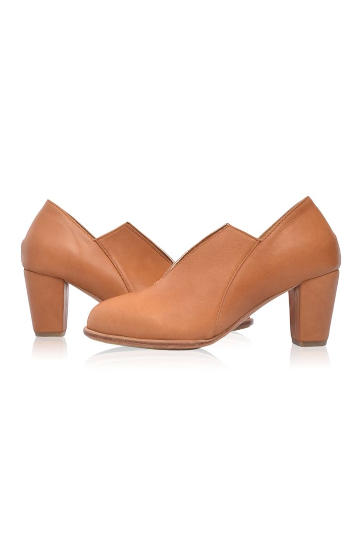 The Ange ankle booties are a must-have for your desk-to-dinner look with the below-ankle height design and leather-wrapped heel. Handcrafted in timeless silhouette, neutral hues, and almond-shaped toe these booties are comfortable and chic enough to become your favorite pair for any occasion. Wear them with your mini or midi dress to elevate your everyday casual look or your skinny jeans for a super chic style. 100% genuine leather Smooth leather lining and insole with embossed logo Lightly padd Chic High Heel Boots With Wooden Heel, Chic Boots With Wooden Block Heel, Formal Pointed Toe Booties With Stacked Heel, Workwear Ankle Boots With Stacked Heel, Fall Office Booties With Closed Toe, Chic Fall Boots With Wooden Heel, Ankle-high Heeled Boots With Stacked Heel For Work, Leather Heeled Boots With Wooden Heel For Fall, High Heeled Boots With Sculpted Heel For Work