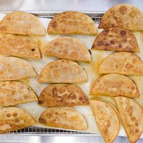 several flat breads on a cooling rack ready to be cooked