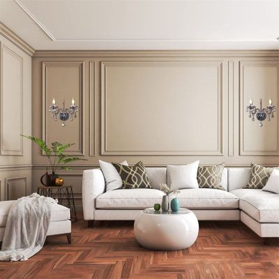 a living room with white furniture and wood flooring on the wooden parqueted floor