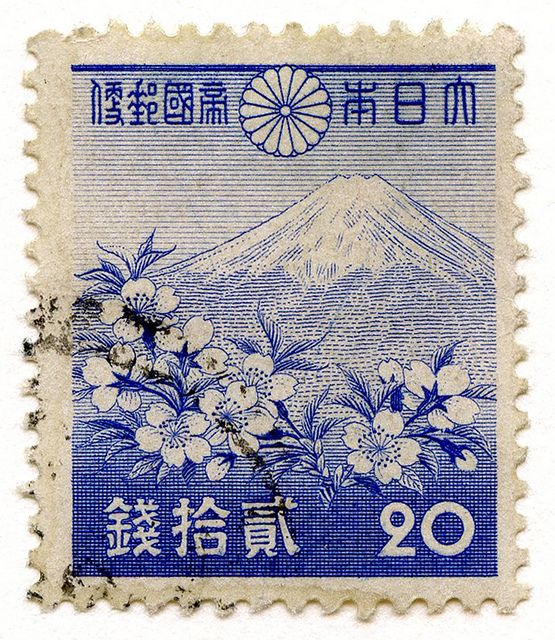 a stamp with flowers and mountains on it