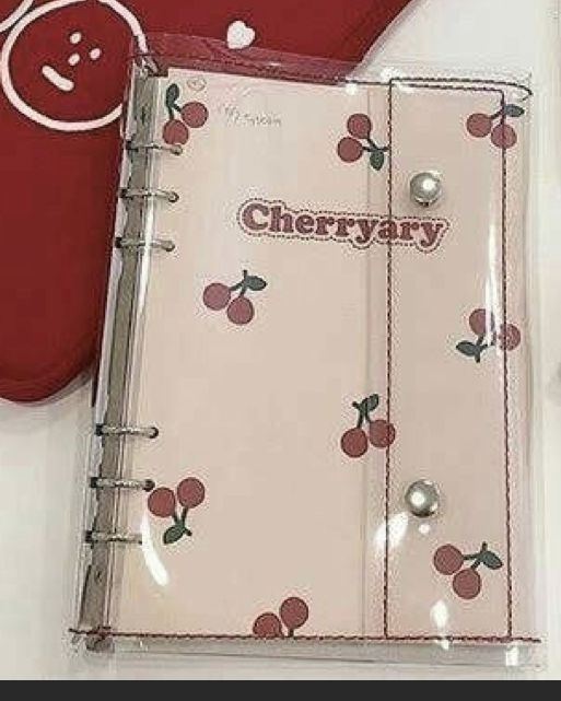 an open cherry themed notebook next to a pair of scissors