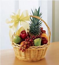 a basket filled with fruit sitting on top of a wooden table