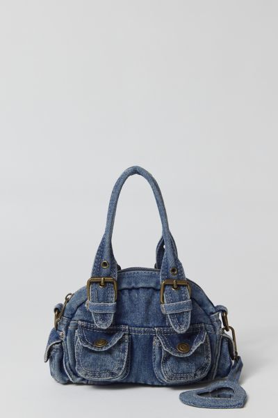 Essential denim bag from BDG with Y2K styling. Mini duffle style with a zippered top and snapped pouch pockets. Trimmed with a hear-shaped mirror charm and finished with a removable crossbody strap. Only at Urban Outfitters. Features. Denim 2000s bag from BDG in a mini silhouette Zipper closure with a removable crossbody strap UO exclusive Content + Care. 100% Cotton Spot clean Imported Denim Y2k Bag, Y2k Duffle Bag, Urban Outfitters Denim Bag, Denim Purses And Bags Old Jeans, Bag Out Of Jeans, Cute Bags And Purses, Cool Purses, 2000s Bags, Cool Bags