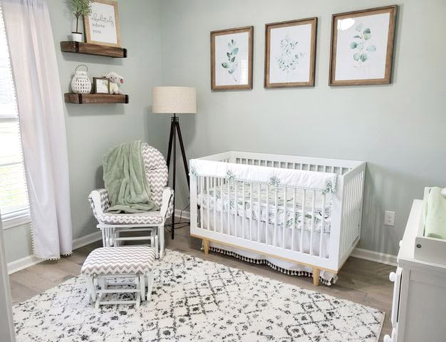 a baby's room is decorated in white and green