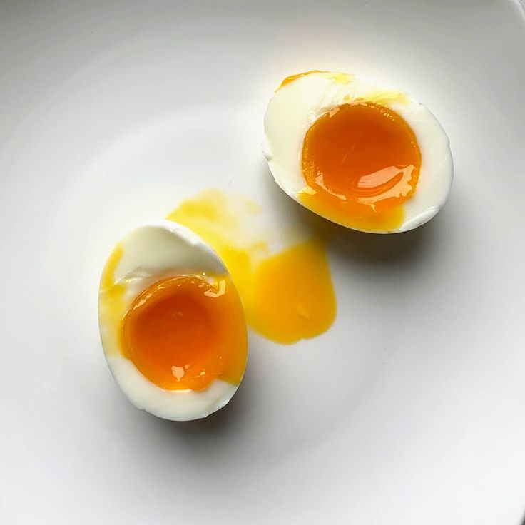 two hard boiled eggs on a white plate