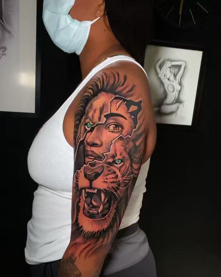 a woman with a lion tattoo on her arm